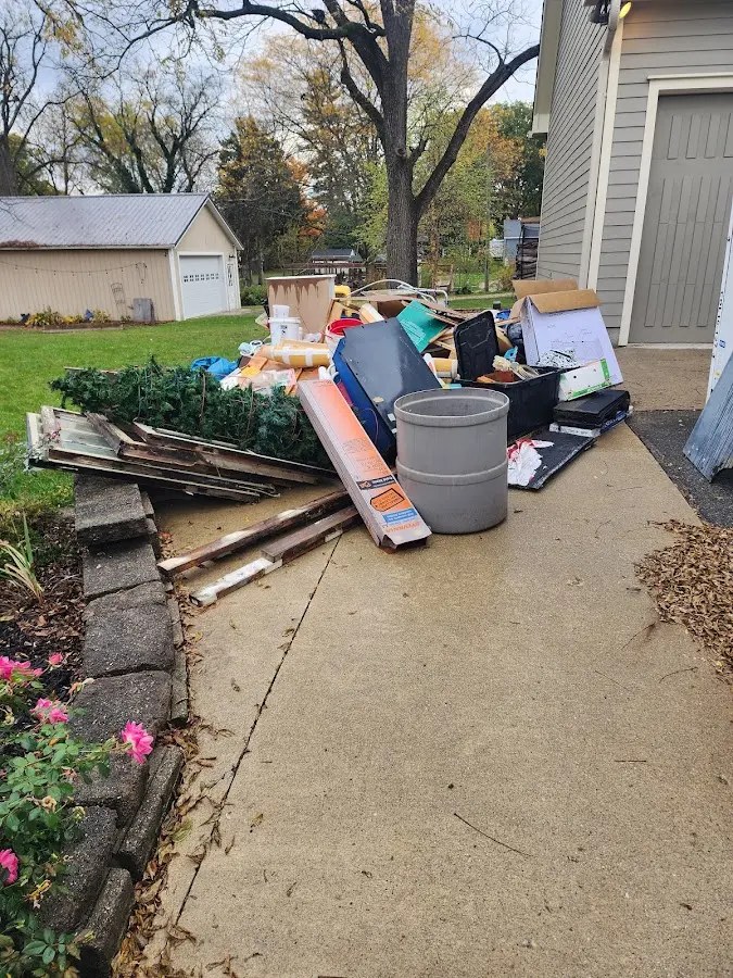Dumpster being loaded with debris for Estate Cleanout Dumpster Rental in East Highland Park